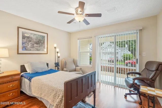 a bedroom with a bed a couch and a large window