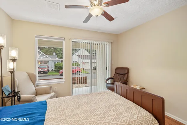 a bedroom with furniture and a large window