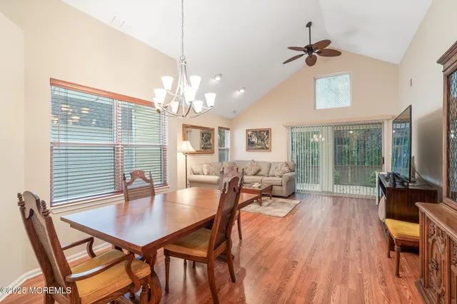 a dining room with furniture window and wooden floor
