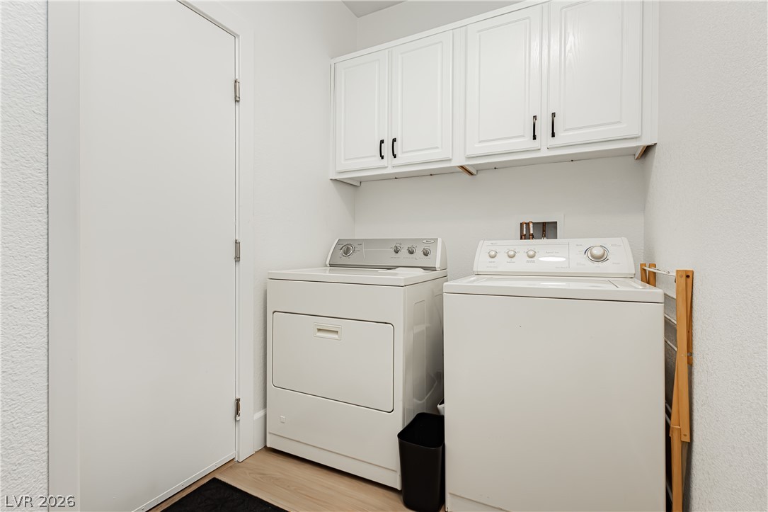 2256 Dogwood Ranch Avenue Henderson, NV 89052 - Photo 42 of 51 Functional laundry space featuring convenient upper cabinetry for storage.