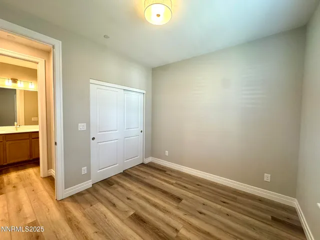 a view of a room with wooden floor and doors
