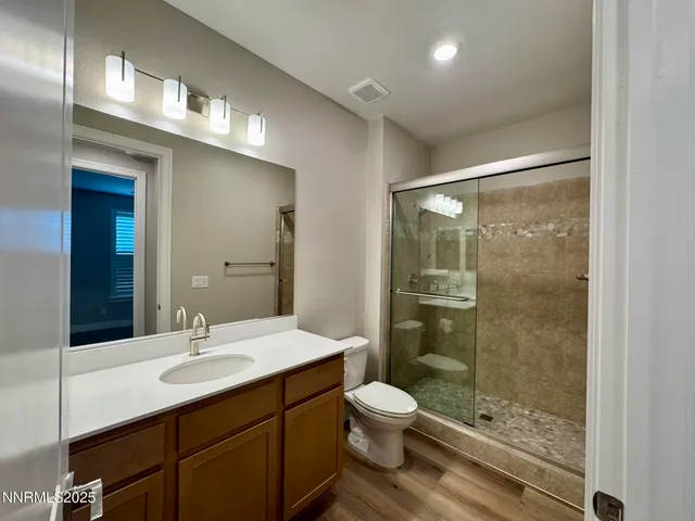 a bathroom with a sink shower and a toilet