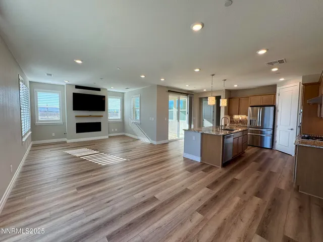 a view of kitchen with cabinets microwave and stove