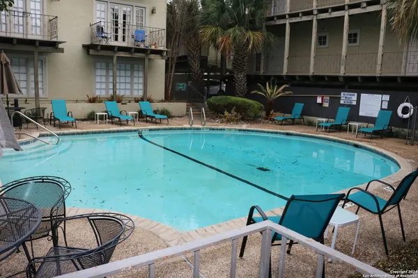 a backyard of a house with table and chairs