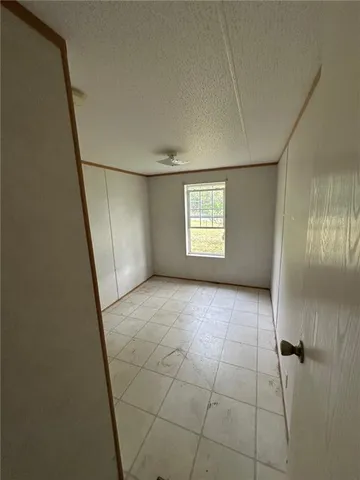 a bathroom with a granite countertop sink mirror vanity and toilet