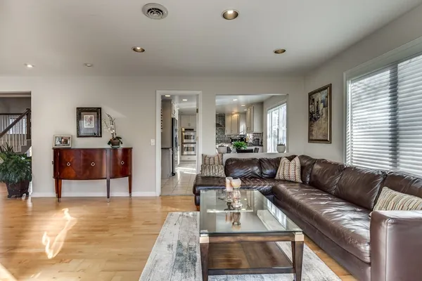 a living room with furniture and a wooden floor