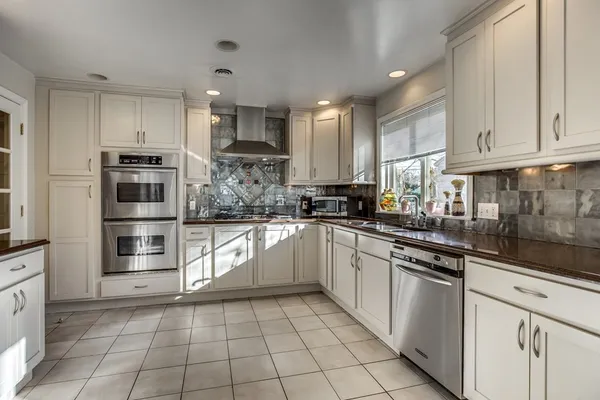 a kitchen with stainless steel appliances cabinets a sink and a counter top space
