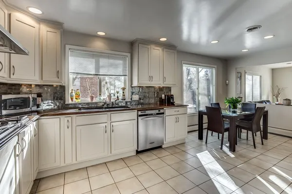 a kitchen with sink cabinets and chairs