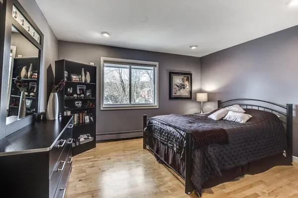 a bedroom with furniture and a wooden floor