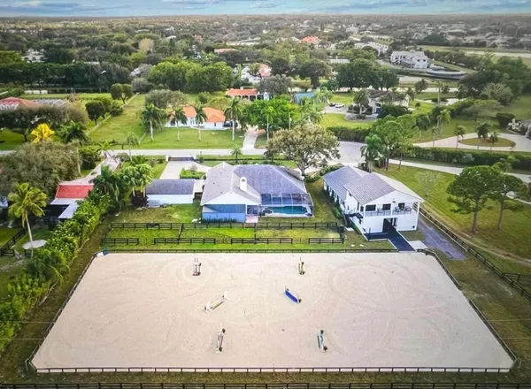 an aerial view of house with yard swimming pool and outdoor seating