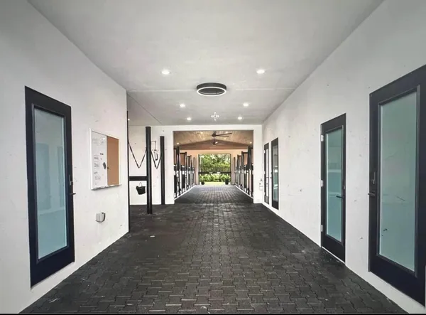 a view of a hallway with wooden floor and entryway