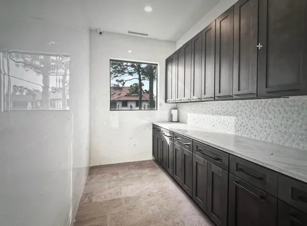 a kitchen with sink cabinets and window