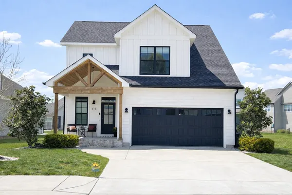 a front view of a house with a yard and garage