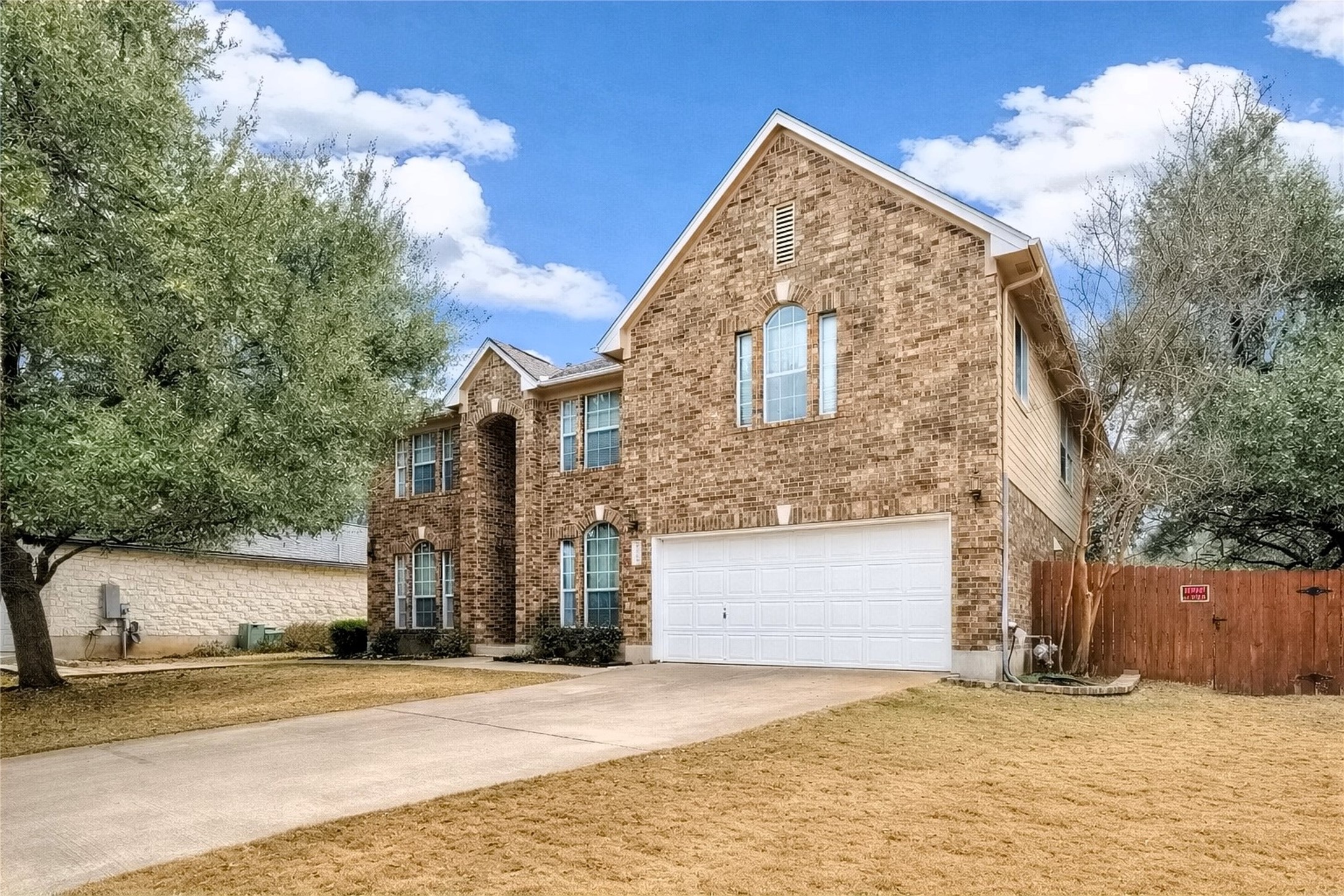 4008 Springwillow Lane Round Rock, TX 78681 - Photo 19 of 29 View of front home featuring driveway, an attached garage, and brick siding