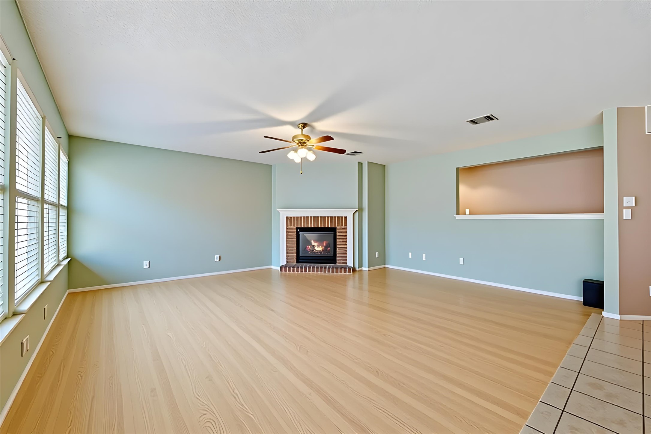 4008 Springwillow Lane Round Rock, TX 78681 - Photo 3 of 29 Virtually staged - Living area featuring a brick fireplace, light tile patterned floors, light colored carpet, and a textured ceiling