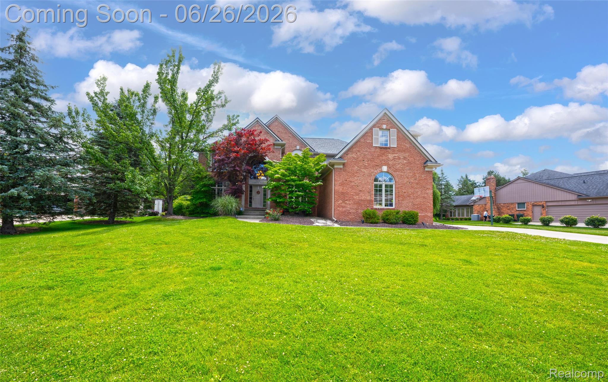2619 Lambeth Park Rochester, MI 48306 - Photo 1 of 71 Brick-clad residence featuring a front gabled dormer, arched window, and mature landscaping