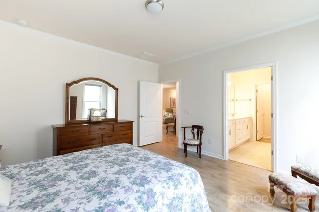 a bedroom with a bed and a dresser with mirror