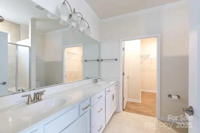 a spacious bathroom with a double vanity sink mirror and next to a window