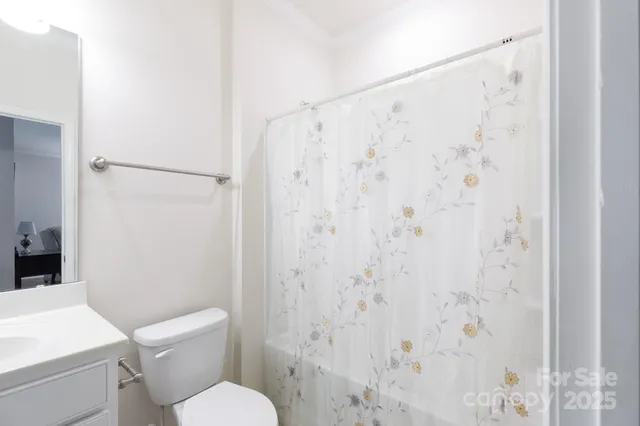 a white toilet sitting next to a bathroom sink