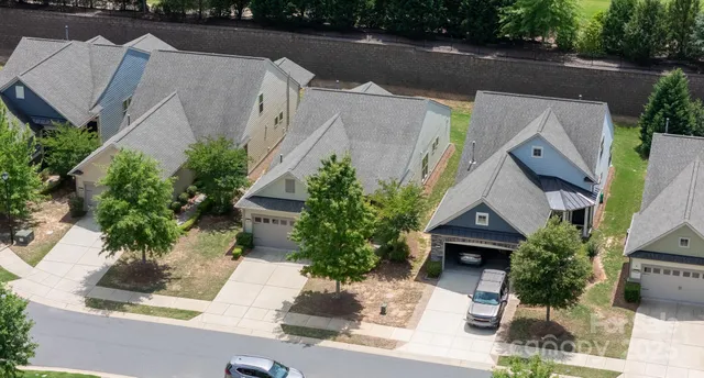 an aerial view of a house with garden space and street view