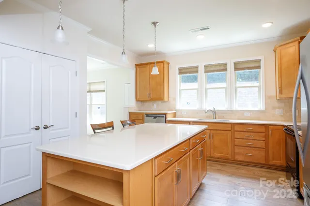 a kitchen with a sink stove and cabinets