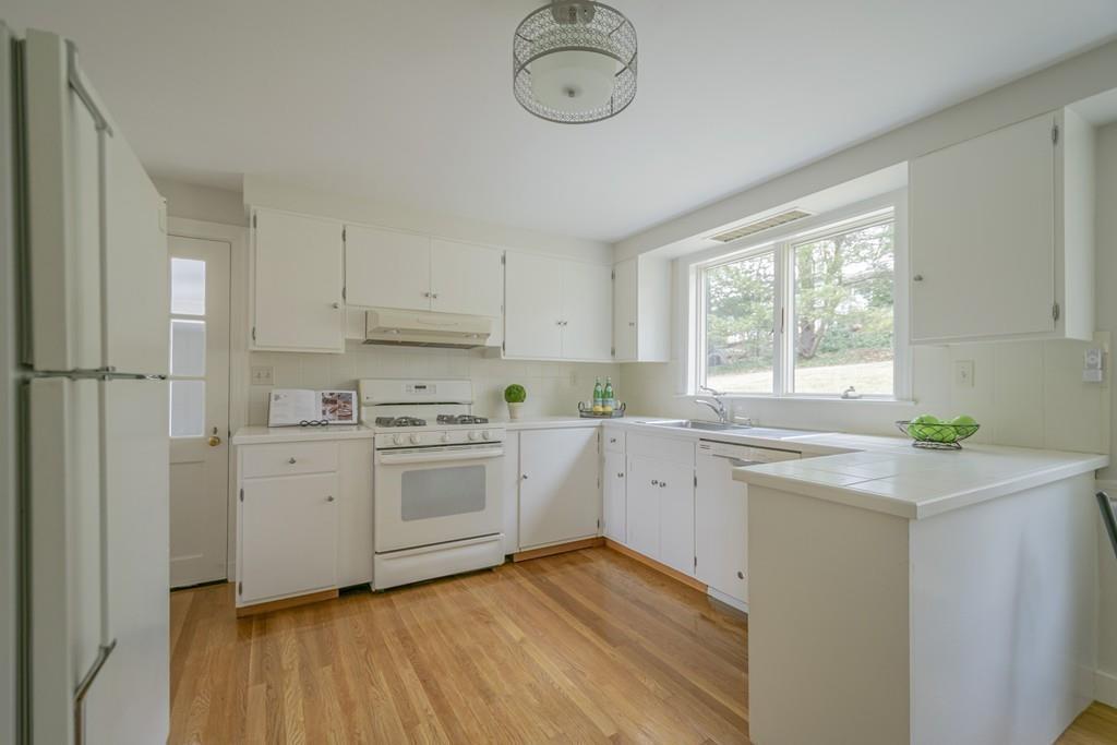 5 Constitution Road Lexington, MA 02421 - Photo 12 of 42 a kitchen with a sink cabinets appliances and a window