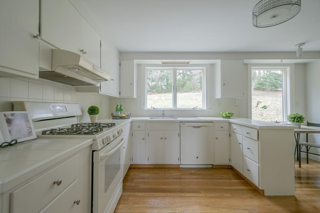 5 Constitution Road Lexington, MA 02421 - Photo 13 of 42 a kitchen with cabinets appliances a sink and a window