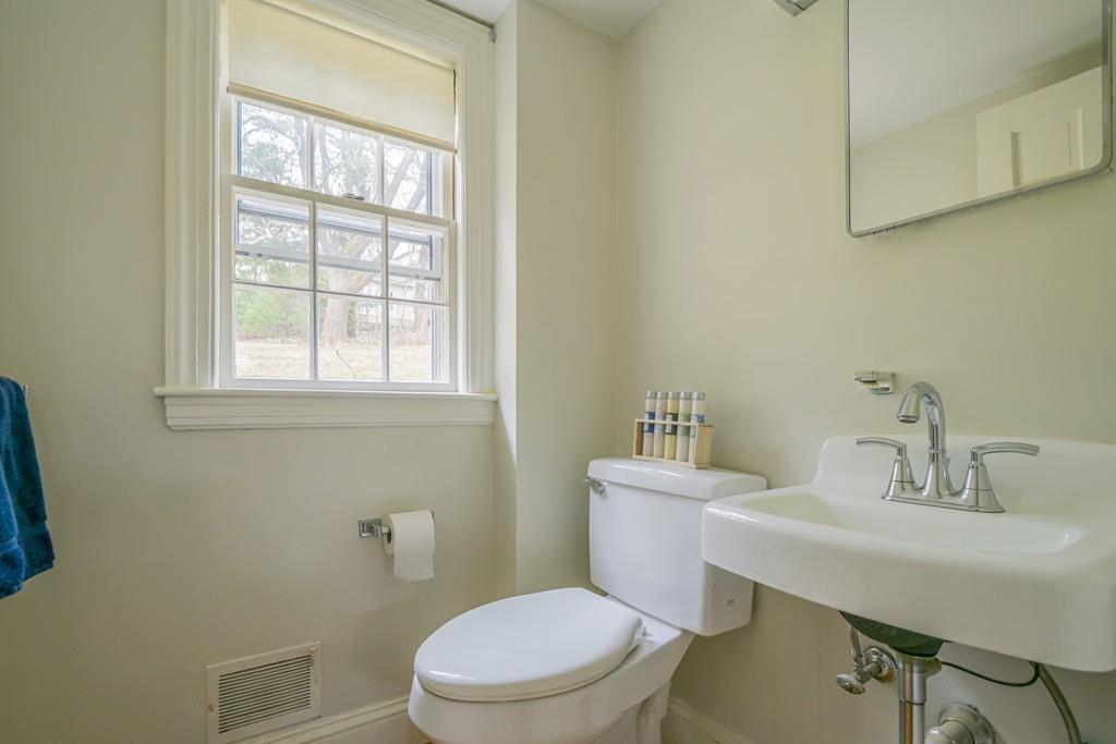 5 Constitution Road Lexington, MA 02421 - Photo 18 of 42 a bathroom with a sink a toilet and a window