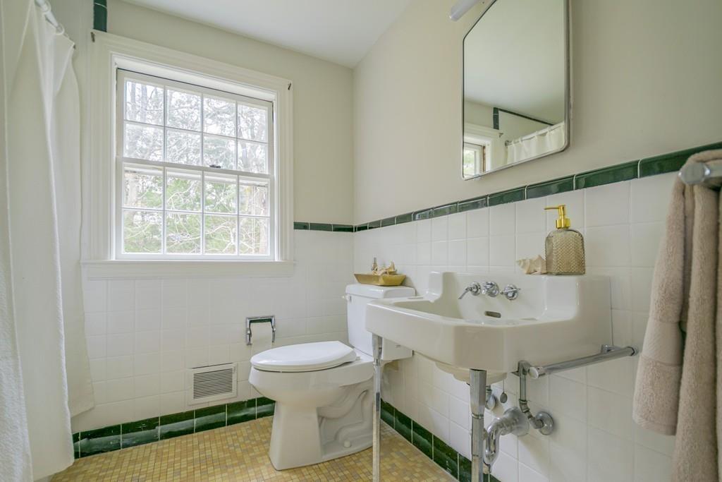 5 Constitution Road Lexington, MA 02421 - Photo 30 of 42 a bathroom with a sink toilet and mirror