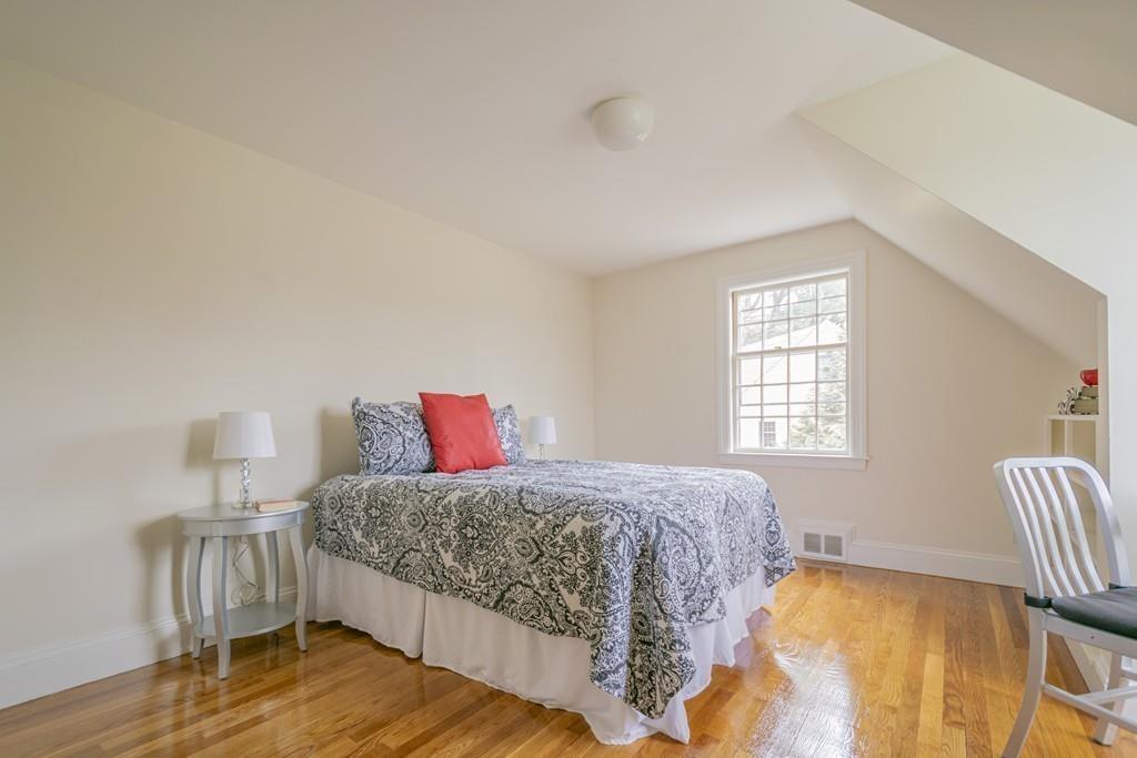 5 Constitution Road Lexington, MA 02421 - Photo 33 of 42 a bedroom with a bed and wooden floor