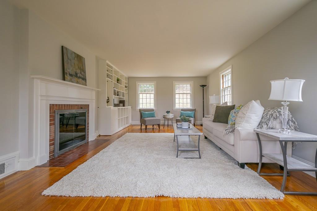 5 Constitution Road Lexington, MA 02421 - Photo 6 of 42 a living room with furniture and a fireplace