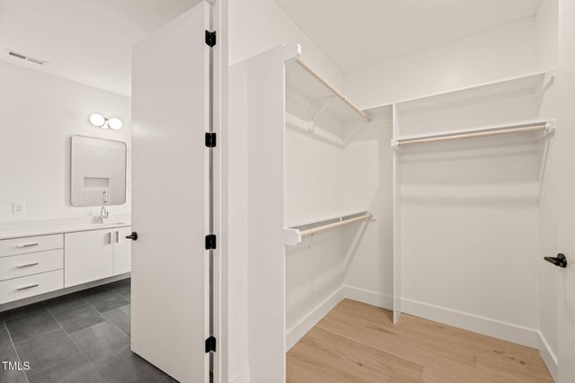a bathroom with a shower sink and mirror