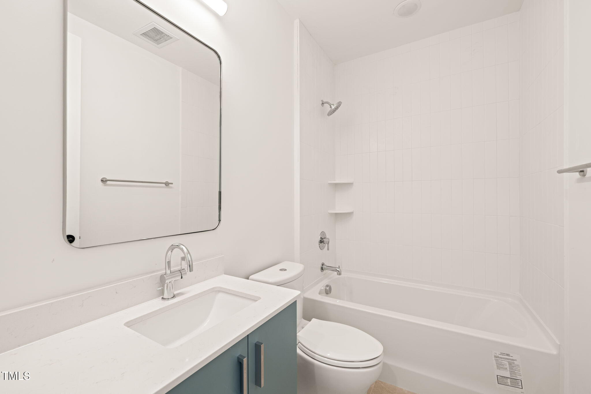 29 Enterprise Street, Unit 110 Raleigh, NC 27607 - Photo 19 of 43 a bathroom with a bathtub shower sink vanity mirror and toilet