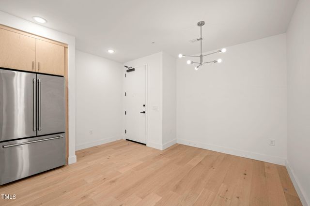 a view of a kitchen with a refrigerator and a microwave