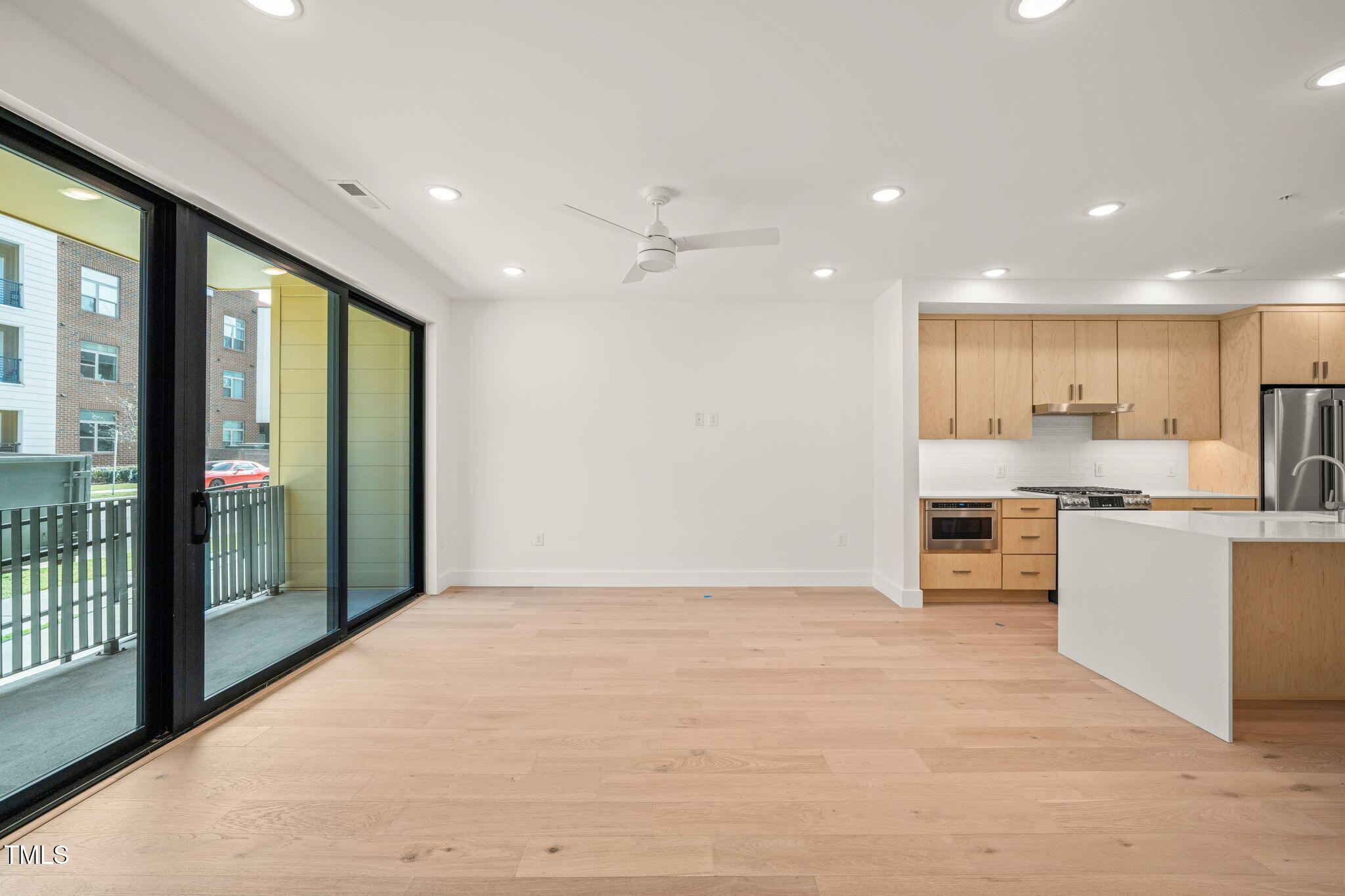 29 Enterprise Street, Unit 110 Raleigh, NC 27607 - Photo 10 of 43 a view of kitchen with stainless steel appliances kitchen island wooden floor and window