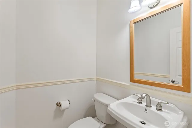 a bathroom with a sink a mirror and a toilet