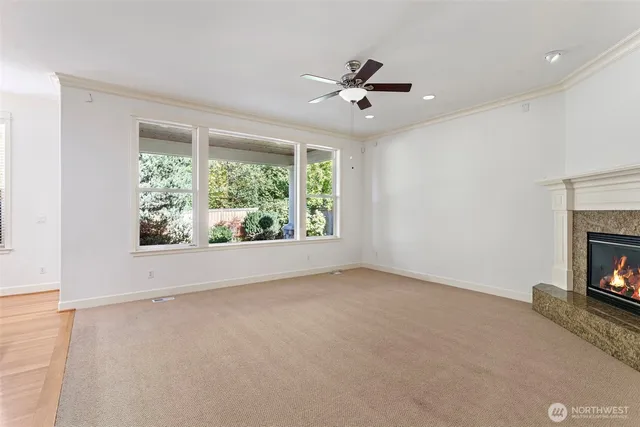 a view of empty room with window and fireplace