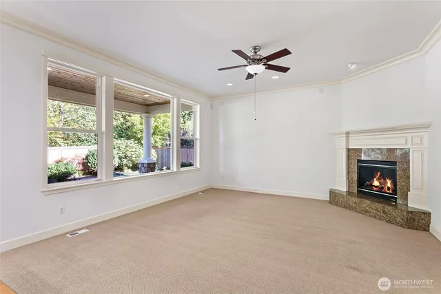 a view of an empty room with window and fire place