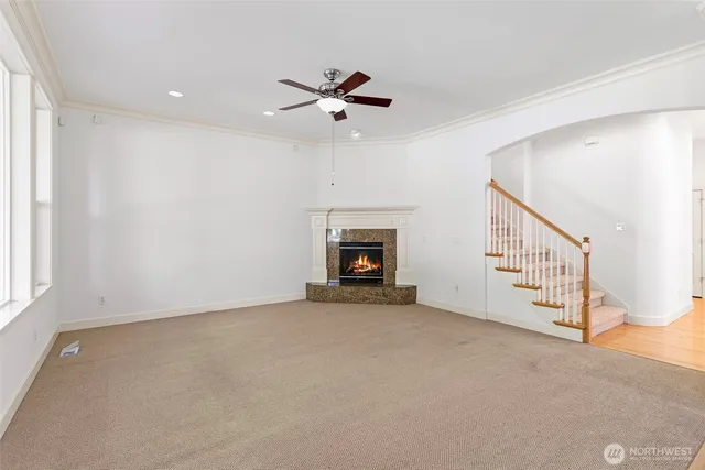 a view of an empty room with a fireplace and a window