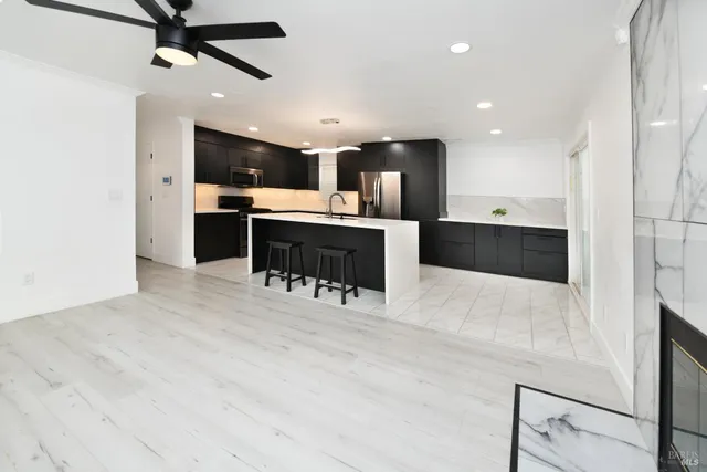 a kitchen with stainless steel appliances kitchen island wooden cabinets and granite counter tops