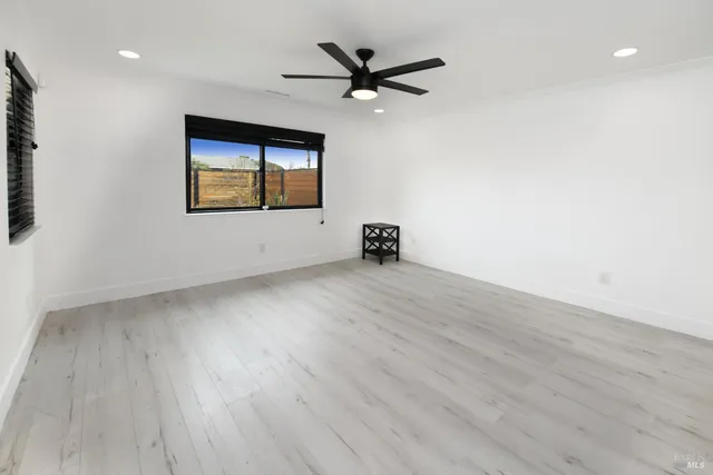 a kitchen with a sink a refrigerator and chairs