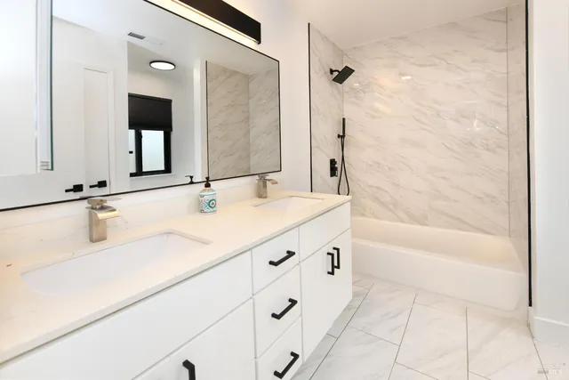 a bathroom with a shower and a mirror