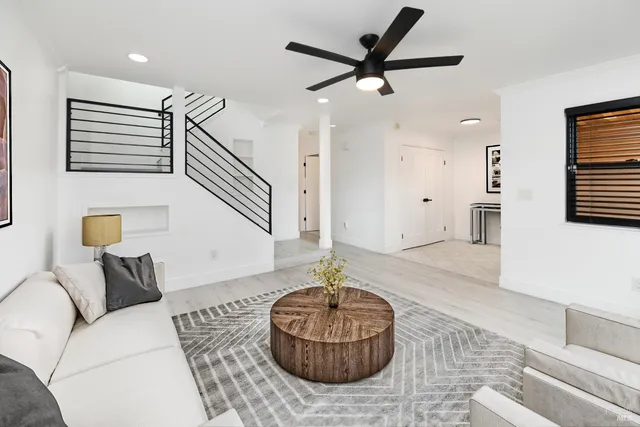 a living room with furniture a flat screen tv and a fireplace