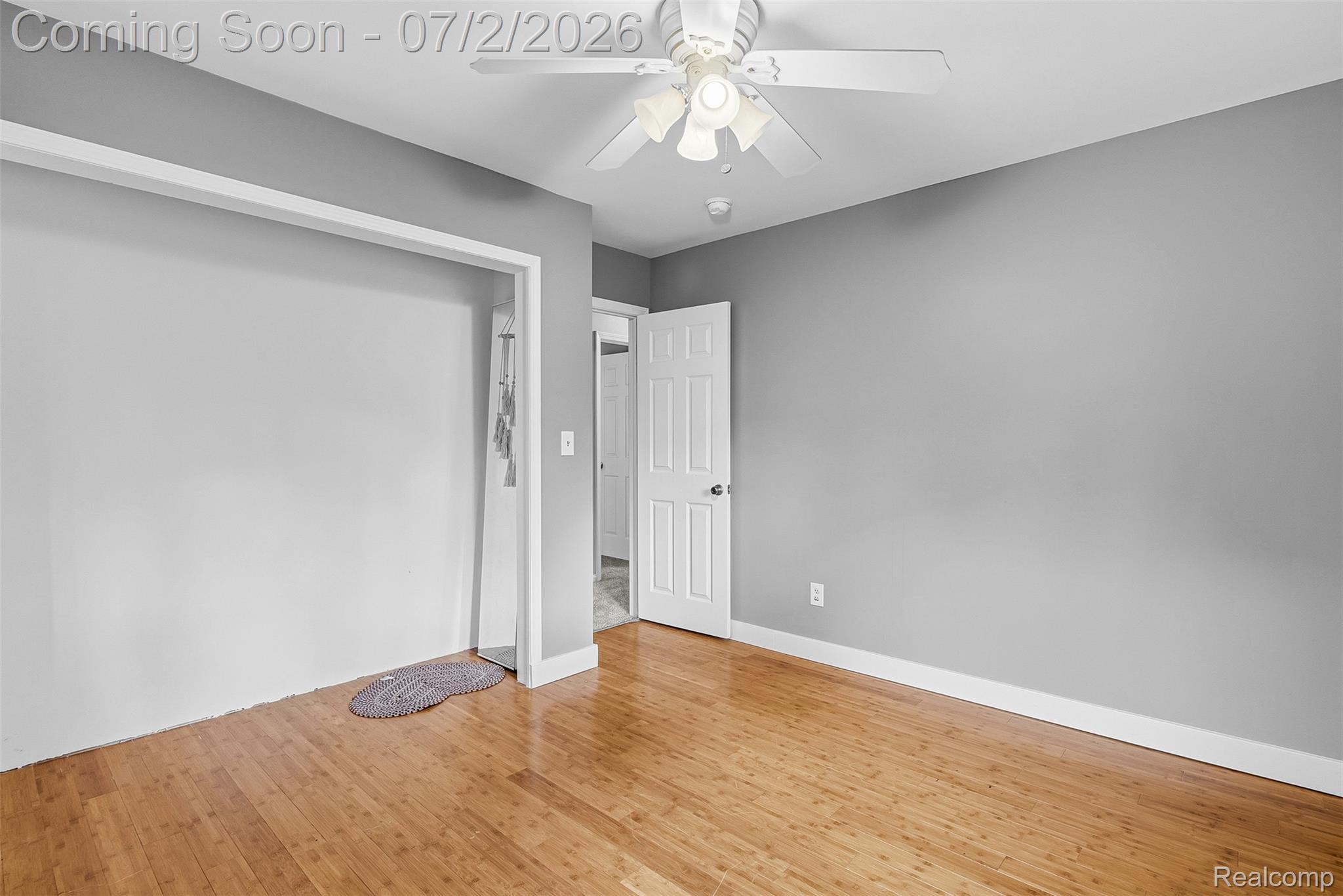 305 East Road Holly, MI 48442 - Photo 21 of 41 Room featuring light gray walls, wood-finish flooring, white trim, and a ceiling fan with integrated lighting