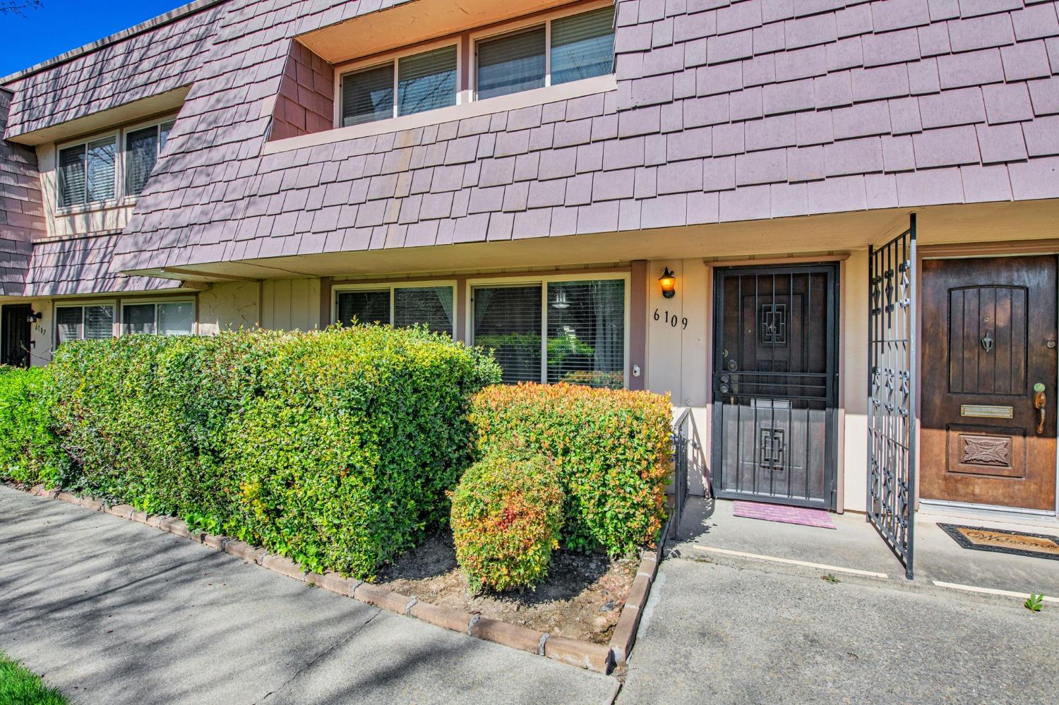 a front view of a building with garden