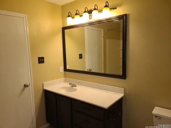 a bathroom with a sink vanity and a mirror