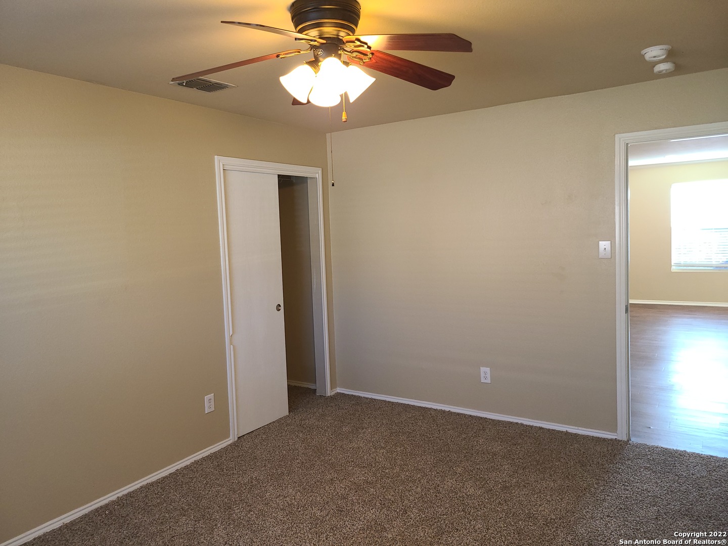 112 Willow Run Cibolo, TX 78108 - Photo 17 of 21 an empty room with a chandelier fan and windows