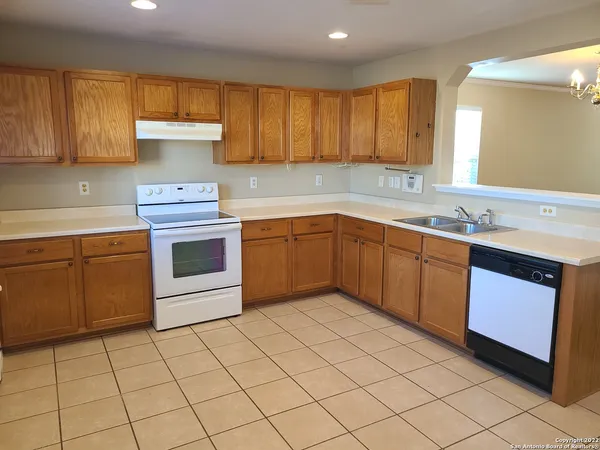 a kitchen with a sink a stove and cabinets