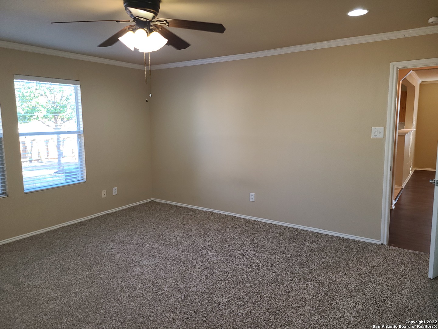 112 Willow Run Cibolo, TX 78108 - Photo 9 of 21 en empty room with windows and chandelier fan