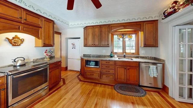 a kitchen with stainless steel appliances granite countertop a stove and a microwave